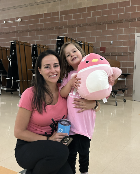 After Glow in the Dark Dodgeball, 2024 Wish Kid Kiki and her mom Desiree pose for a photo  with Kiki’s new squishmallow, a gift from student council,  moments after picking winners from the duck toss March 7. Kiki spent the night dancing to the music and watching the tournament. “I had a great time,” Kiki said.